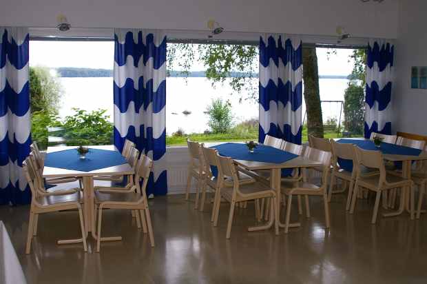 The main room at Järvelä overlooks the lawn and the lake beyond